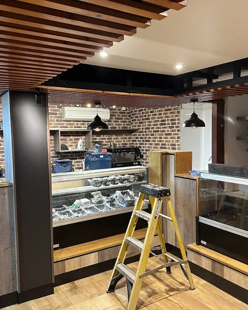 Caf&eacute; fit-out with pendant and downlighting, electrics in progress