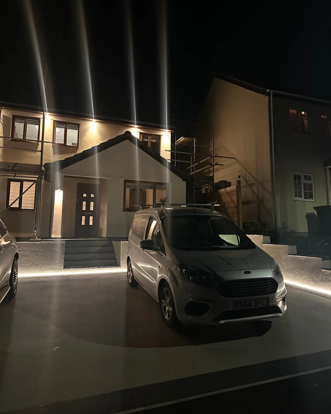Recessed driveway LEDs and fascia spotlights at dusk, with the Somerset Sparks van